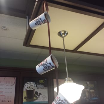 Second Cup - two coffee cups hanging from a ceiling - Coffee & Tea Near Me - Ottawa, Ontario