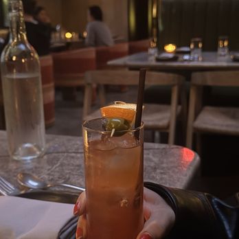 Si! Mon - aperol spritz in a tall glass with an olive as a garnish - Latin American Near Me - Los Angeles, California Si! Mon - aperol spritz in a tall glass with an olive as a garnish - Latin American Near Me - Los Angeles, California