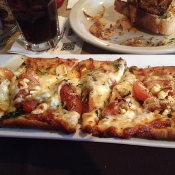The Common Man Restaurant - Roasted tomatoes, spinach, caramelized onions, feta and mozzarella with an olive oil and honey drizzle Flatbread - American Near Me - Lincoln, New Hampshire The Common Man Restaurant - Roasted tomatoes, spinach, caramelized onions, feta and mozzarella with an olive oil and honey drizzle Flatbread - American Near Me - Lincoln, New Hampshire