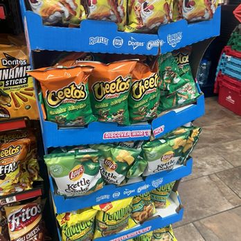 Circle K - a display of chips and other snacks - Display shelf with snack bags including Buffalo, Cheetos, Lay's Kettle Cooked, and Funyuns, arranged in multiple rows. - Fast Food Near Me - Pelham, Alabama