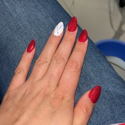 Gel Almond Shaped Acrylic Nails with marble design on ring finger Gel Almond Shaped Acrylic Nails with marble design on ring finger