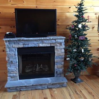 Colonial Properties - Stone fireplace and Christmas tree in Bear Cub Den - Property Management Near Me - Pigeon Forge, Tennessee Colonial Properties - Stone fireplace and Christmas tree in Bear Cub Den - Property Management Near Me - Pigeon Forge, Tennessee