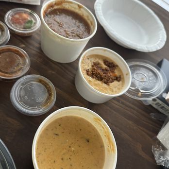 Torchy's Tacos - Queso with chipotle beef, queso without and salsa and chips. They also included small cups of salsa. - Tex-Mex Near Me - Houston, Texas