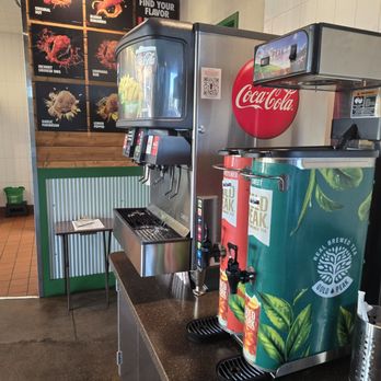 Wingstop - a counter with a soda machine and a coke machine - Chicken Wings Near Me - Buckeye, Arizona
