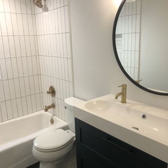 Smalltown Home Improvement - a bathroom with a sink, toilet, and bathtub - General Contractors Near Me Smalltown Home Improvement - a bathroom with a sink, toilet, and bathtub - General Contractors Near Me