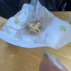 Food almost gone about to lick the wrapping paper
