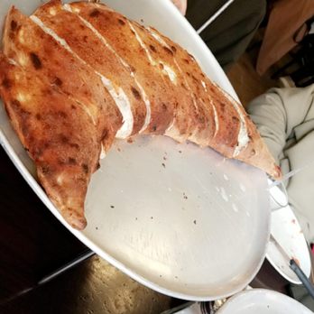 Juliana's - This is the large calzone, feeds 4 people. Or 3 if you eat alot lol I would order a side of marinara sauce to go with it for more flavor - Pizza Near Me - Brooklyn, New York Juliana's - This is the large calzone, feeds 4 people. Or 3 if you eat alot lol I would order a side of marinara sauce to go with it for more flavor - Pizza Near Me - Brooklyn, New York