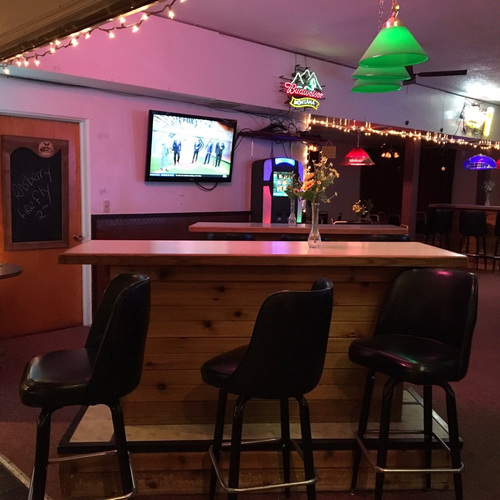 The Coyote Club - a bar with stools and a television - Pubs Near Me - Shelby, Montana The Coyote Club - a bar with stools and a television - Pubs Near Me - Shelby, Montana