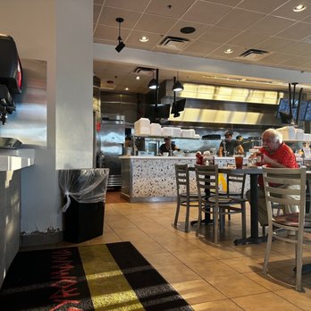 Gyromania Grill - a group of people sitting at a table - Greek Near Me - Boca Raton, Florida Gyromania Grill - a group of people sitting at a table - Greek Near Me - Boca Raton, Florida