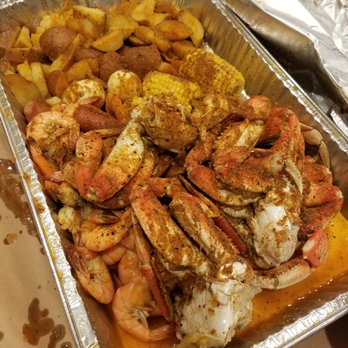 Mad Crab Seafood - Dungeness Crab, Garlic Shrimp, boiled eggs, potatoes  corn on the cob..  This food was ABSOLUTELY AMAZINGLY Delicious - Seafood Near Me - Orlando, Florida