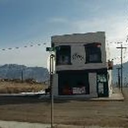 a small white building on the side of the road