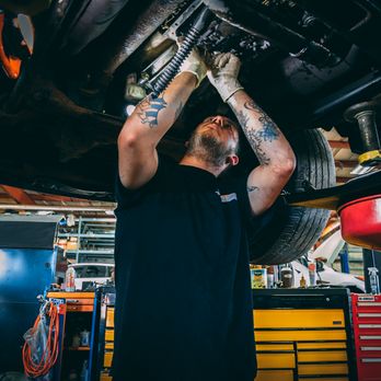 Service Garage - An auto technician hard at work on a repair. - Auto Repair Near Me - Appleton, Wisconsin Service Garage - An auto technician hard at work on a repair. - Auto Repair Near Me - Appleton, Wisconsin