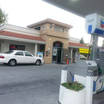 Chevron - a gas station with a white car parked in front of it - Gas Stations Near Me - Sunnyvale, California