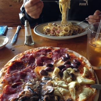 Il Borgo - Quatro Pizza (Proscriutto, mushroom, olive, & artichoke) with pasta carbonara in the background. Yumma - Italian Near Me - San Francisco, California