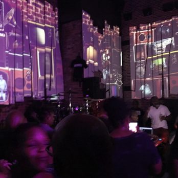 The Rockwell - a crowd of people watching a video - Bars Near Me - Baltimore, Maryland