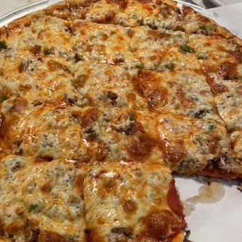 Basil's Pizza Palace - Beautiful pizza with a slice already gone! - Pizza Near Me - Northfield, Minnesota