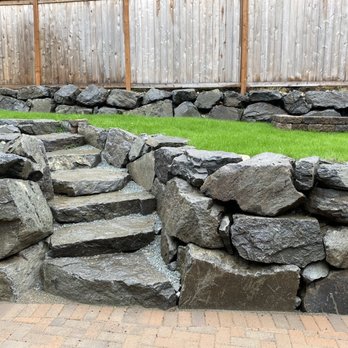 Seattle Rockeries - a large pile of rocks in a backyard - Landscaping Near Me Seattle Rockeries - a large pile of rocks in a backyard - Landscaping Near Me