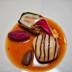 Tantris - Scallop two ways, topped with fermented black garlic and stuff with white truffles, wrapped in spinach and tempura fried