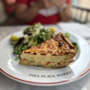 Café Campagne - a slice of quiche on a plate - French Near Me - Seattle, Washington Café Campagne - a slice of quiche on a plate - French Near Me - Seattle, Washington