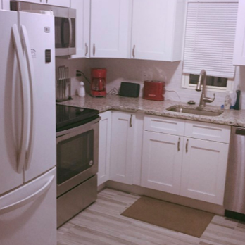 ODAAT Contracting - a kitchen with white cabinets and stainless steel appliances - Decks & Railing Near Me - Levittown, Pennsylvania