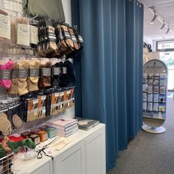 Grand Jete - Dance socks, books and accessories display, fitting rooms, and Bunheads display.