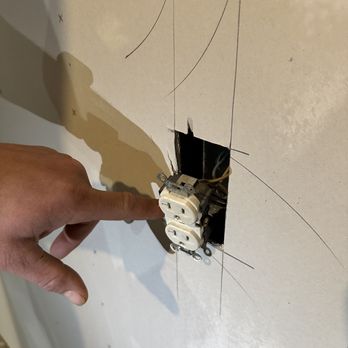 JMH Construction - a hand pointing at a broken electrical outlet - General Contractors Near Me JMH Construction - a hand pointing at a broken electrical outlet - General Contractors Near Me