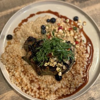 Gather in Jackson Hole - Pork ribeye with Israeli couscous and pickled blueberries. - New American Near Me - Jackson, Wyoming