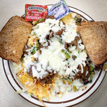 Milda's Café - Philly Scramble - hash browns topped with scrambled eggs, philly beef, sautéed green peppers + onions, and covered in melted cheese. - Breakfast & Brunch Near Me - Minneapolis, Minnesota Milda's Café - Philly Scramble - hash browns topped with scrambled eggs, philly beef, sautéed green peppers + onions, and covered in melted cheese. - Breakfast & Brunch Near Me - Minneapolis, Minnesota