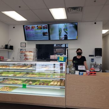 Snowflake Donuts - a woman behind the counter - Donuts Near Me - Mansfield, Texas