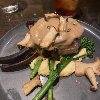 Local Restaurant & Bar - Smoked pork shank over cheesy polenta with broccolini - New American Near Me - Jackson, Wyoming