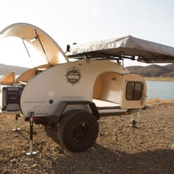 Off The Grid Rentals - Full size bed and free standing awning.