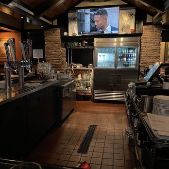 LongHorn Steakhouse - a bar with a television in the background - Steakhouses Near Me - Naples, Florida LongHorn Steakhouse - a bar with a television in the background - Steakhouses Near Me - Naples, Florida