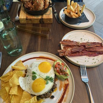 Yardbird - Front to back- Smoked Brisket Huevos Rancheros, Bacon $8, House Fries $10, half Lewellyn's Fine Fried Chicken - New American Near Me - Washington, DC, District of Columbia Yardbird - Front to back- Smoked Brisket Huevos Rancheros, Bacon $8, House Fries $10, half Lewellyn's Fine Fried Chicken - New American Near Me - Washington, DC, District of Columbia