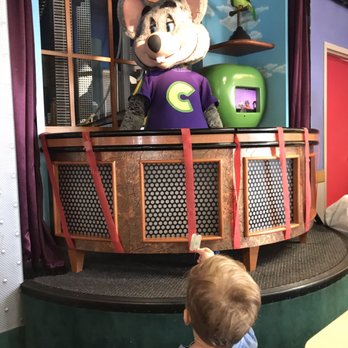 Chuck E. Cheese - a child looking at a display of a mouse - Pizza Near Me - Tulsa, Oklahoma