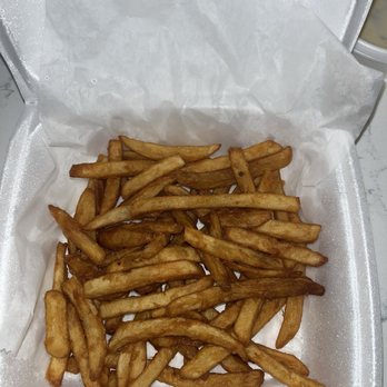 Cielito Lindo - Order of Fries - French fries are served in a foam takeout container lined with white paper, with some fries overlapping each other. - Mexican Near Me - Milwaukee, Wisconsin