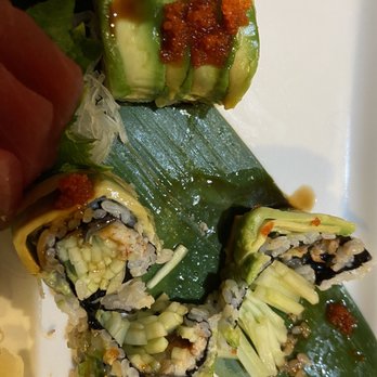 Sushi Suzuki - a hand holding a piece of sushi - Sushi Bars Near Me - Metuchen, New Jersey Sushi Suzuki - a hand holding a piece of sushi - Sushi Bars Near Me - Metuchen, New Jersey