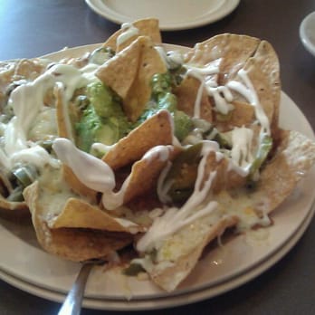 Tio Luis tacos and cafe - Nachos - We asked for no beans, but they stuck all the chips into the beans that's underneath. - Breakfast & Brunch Near Me - Chicago, Illinois Tio Luis tacos and cafe - Nachos - We asked for no beans, but they stuck all the chips into the beans that's underneath. - Breakfast & Brunch Near Me - Chicago, Illinois