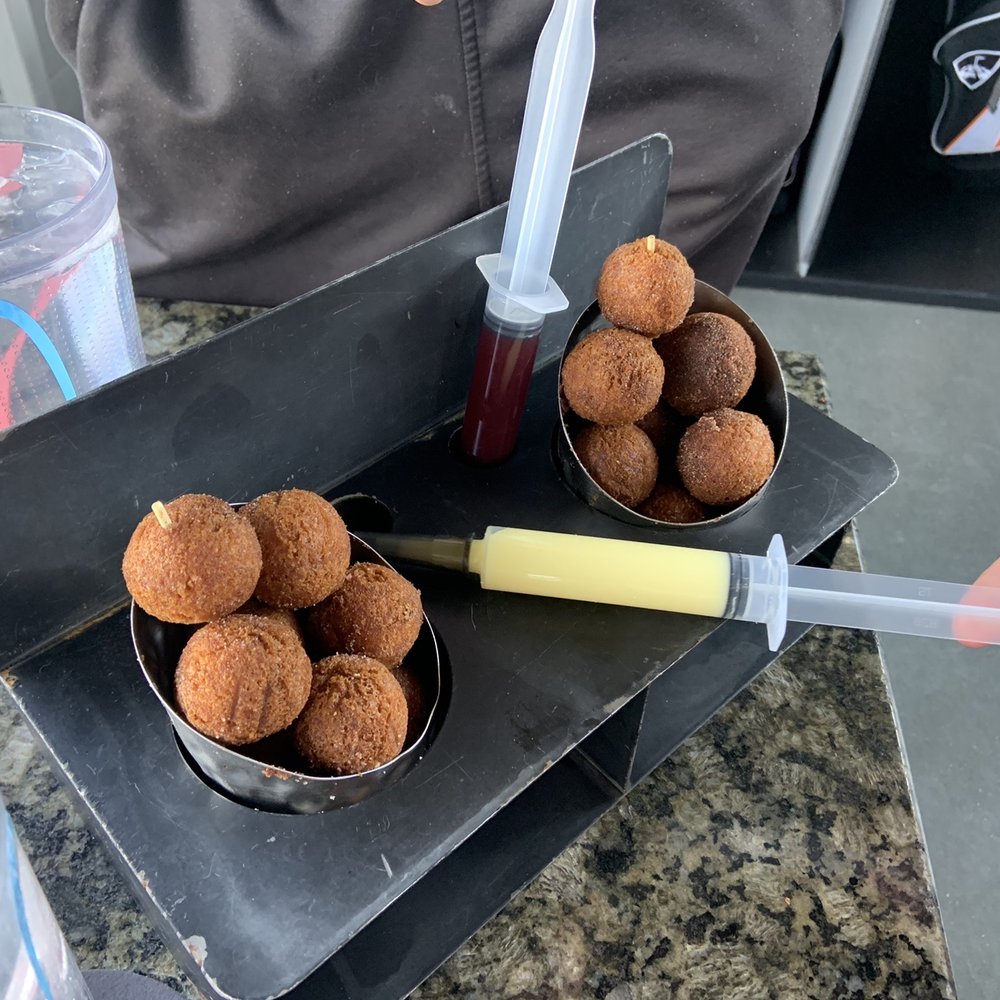 Topgolf - Injectable donut holes with raspberry and custard filling - Sports Bars Near Me - Midvale, Utah Topgolf - Injectable donut holes with raspberry and custard filling - Sports Bars Near Me - Midvale, Utah