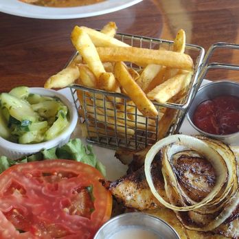 Mo Bay Grill - Blackened grouper sandwich with fries and cucumber salad - Caribbean Near Me - Sebastian, Florida