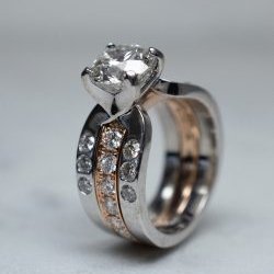 Shelton Jewelers - Try a different finish like this rose gold center diamond band has texture to off set the high shine of the white gold.
