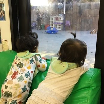 Fremont Paseo Padre KinderCare - Infant Buddies looking out together hoping when will they be able to go out and play - Preschools Near Me - Fremont, California