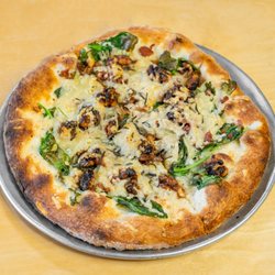 The Wedge Pizzeria - The Truffle Shuffle has roasted chicken, mozzarella and parmesan cheese, mushrooms, spinach, sage, herbs, and truffle oil