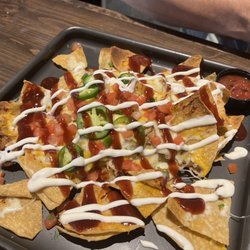 The Tavern on South Shore - BBQ Pork Nachos ($14), During Happy Hour take $5 off