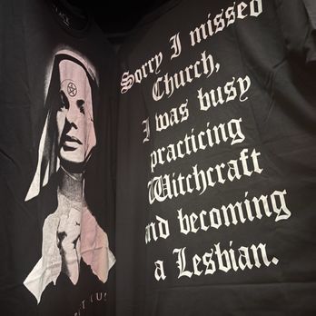 BlackCraft Cult - A black T-shirt features a graphic of a nun with a pentagram on her forehead, and a black jacket displays white gothic text about practicing witchcraft. - Men's Clothing Near Me - Salem, Massachusetts