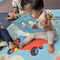 I love how baby is already comfortable looking at books! Thank you teachers for exposing her so early on :)