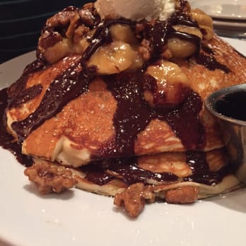 M.A.C. 24/7 - Regular stack of bananas foster pancakes. Smothered in bananas, walnuts, and chocolate ganache with syrup on the side - American Near Me - Honolulu, Hawaii M.A.C. 24/7 - Regular stack of bananas foster pancakes. Smothered in bananas, walnuts, and chocolate ganache with syrup on the side - American Near Me - Honolulu, Hawaii