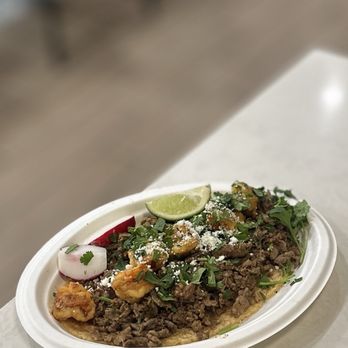 El Torazo - Mega Surf & Turf Taco: grilled shrimp, carne asada w/caramelized onions, guaca salsa, cilantro & cotija cheese w/corn/flour tortilla | $9.99 - Mexican Near Me - Huntington Beach, California El Torazo - Mega Surf & Turf Taco: grilled shrimp, carne asada w/caramelized onions, guaca salsa, cilantro & cotija cheese w/corn/flour tortilla | $9.99 - Mexican Near Me - Huntington Beach, California