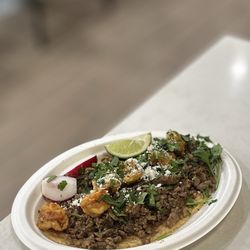 El Torazo - Mega Surf & Turf Taco: grilled shrimp, carne asada w/caramelized onions, guaca salsa, cilantro & cotija cheese w/corn/flour tortilla | $9.99