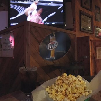 Whiskey Smith - a basket of popcorn in front of a television - Dive Bars Near Me - San Antonio, Texas