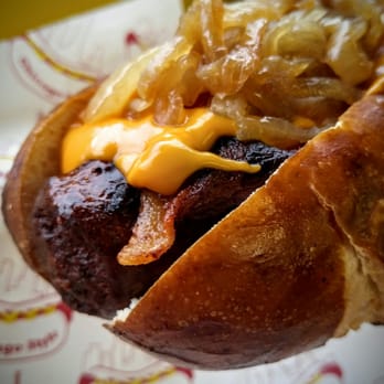 Scooters - Bacon, Merkts cheddar, grilled onions on a pretzel bun. The Scooter Brat. - Hot Dogs Near Me - Lake Bluff, Illinois